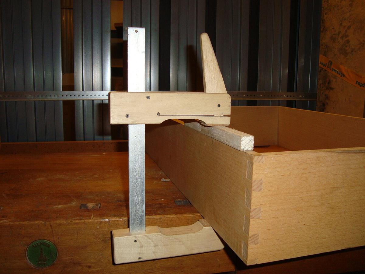 A Klemmsia wooden cam clamp holding the side of a box