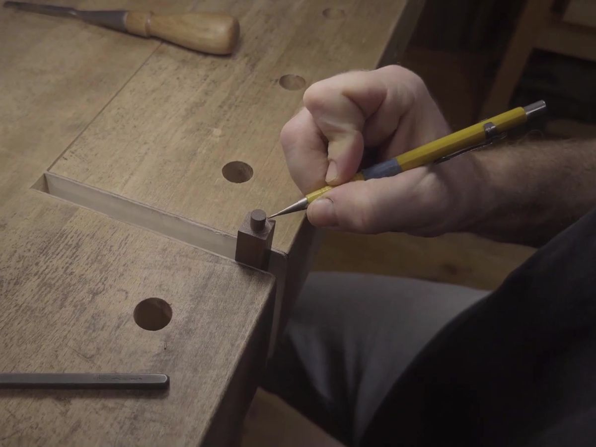 Marking a line with a 0.9 mm mechanical pencil against a small square