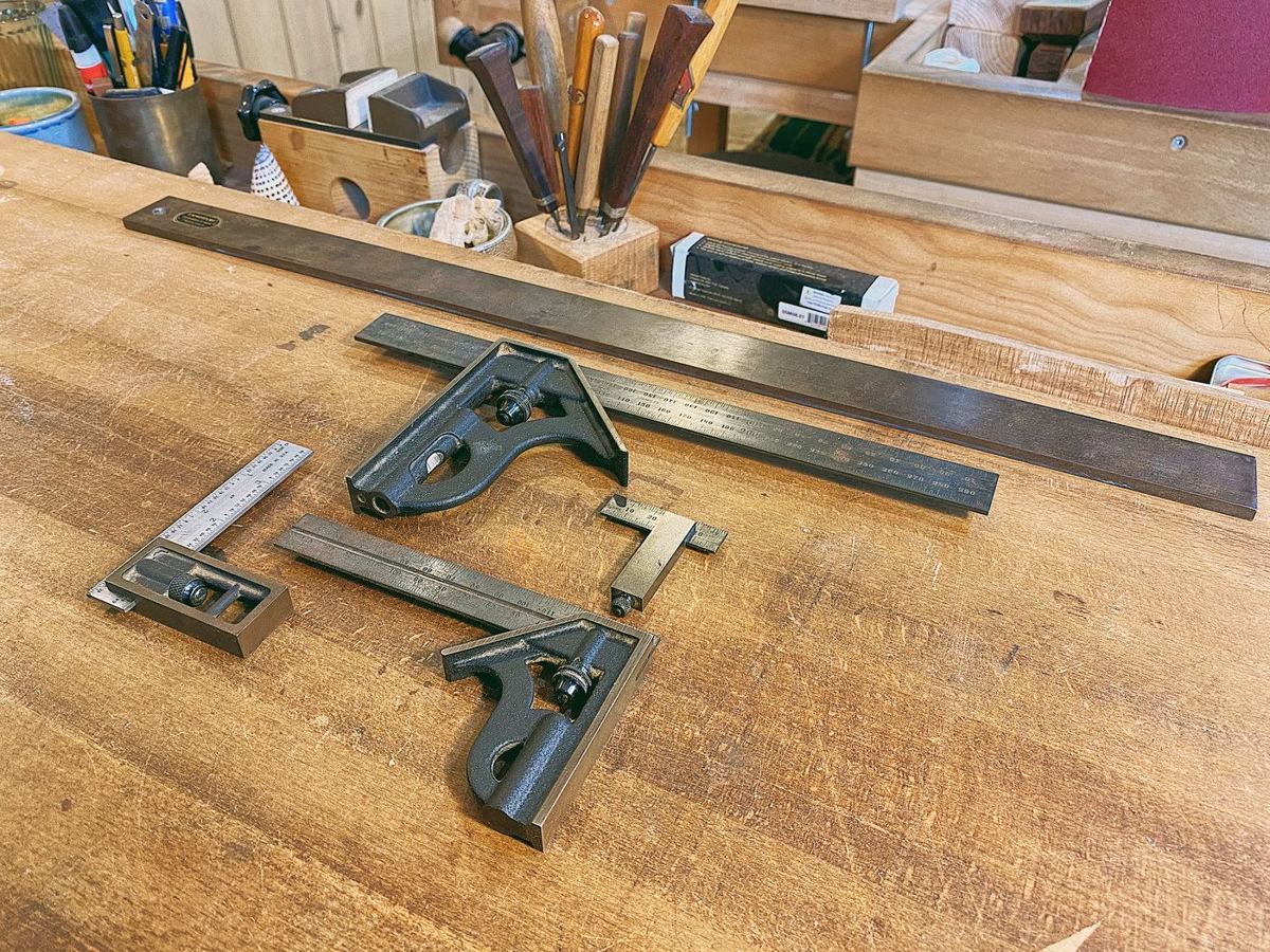 Rafael's Starrett squares laid out on the bench, with a long straightedge above them